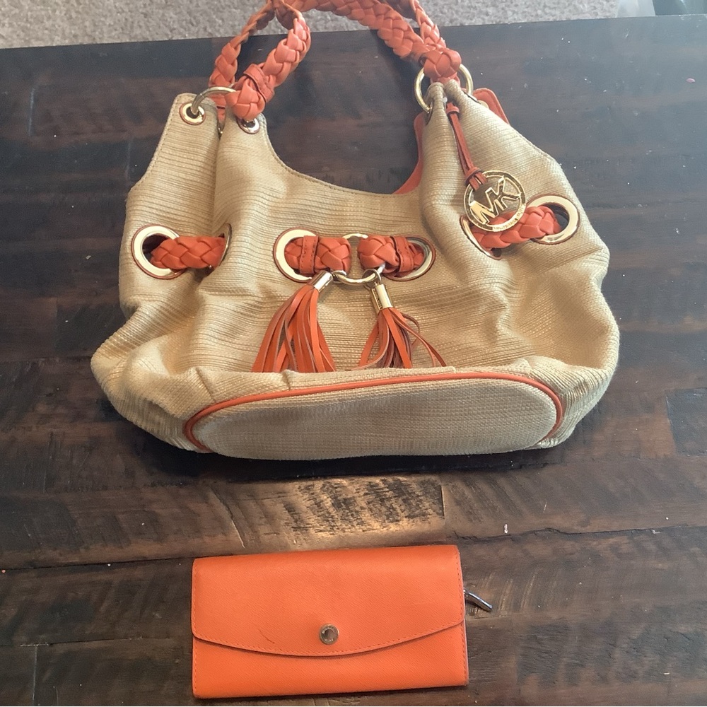 Michael Kors orange and rattan colored purse and orange wallet.